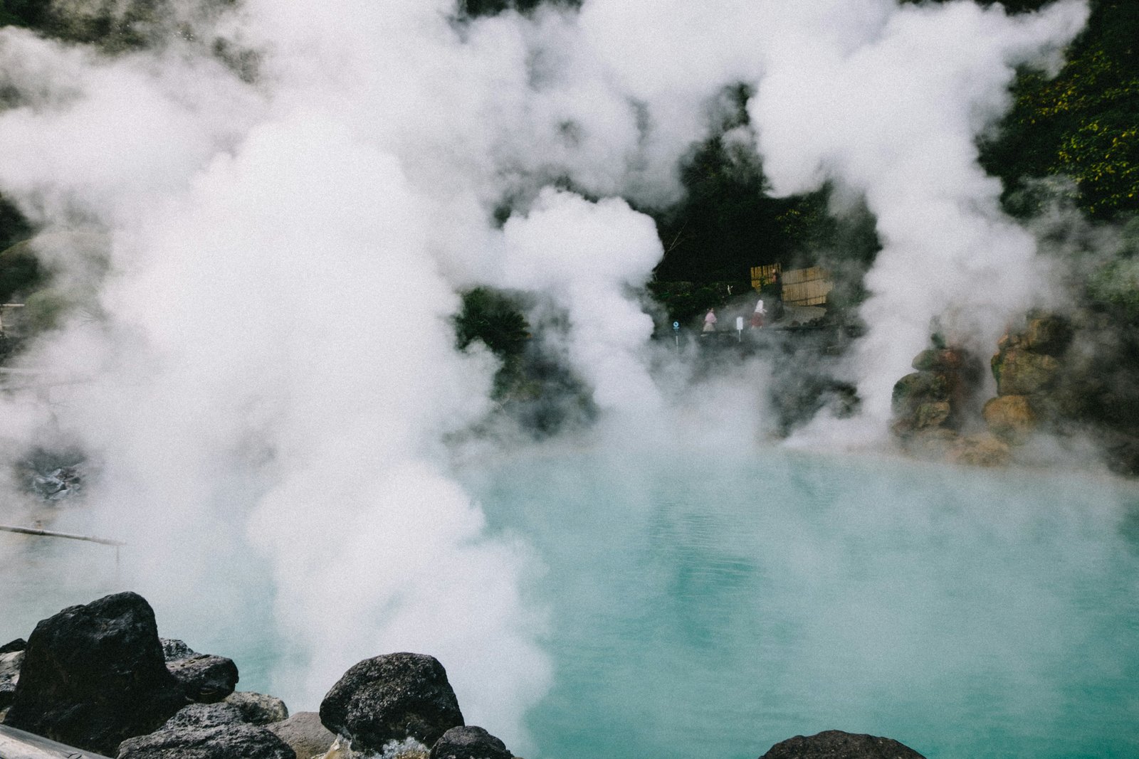 Beppu hell pools — turquoise hot spring water rising with steam