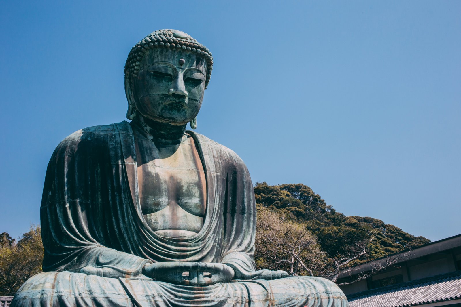 The Great Buddha of Kamakura seated against a clear blue sky