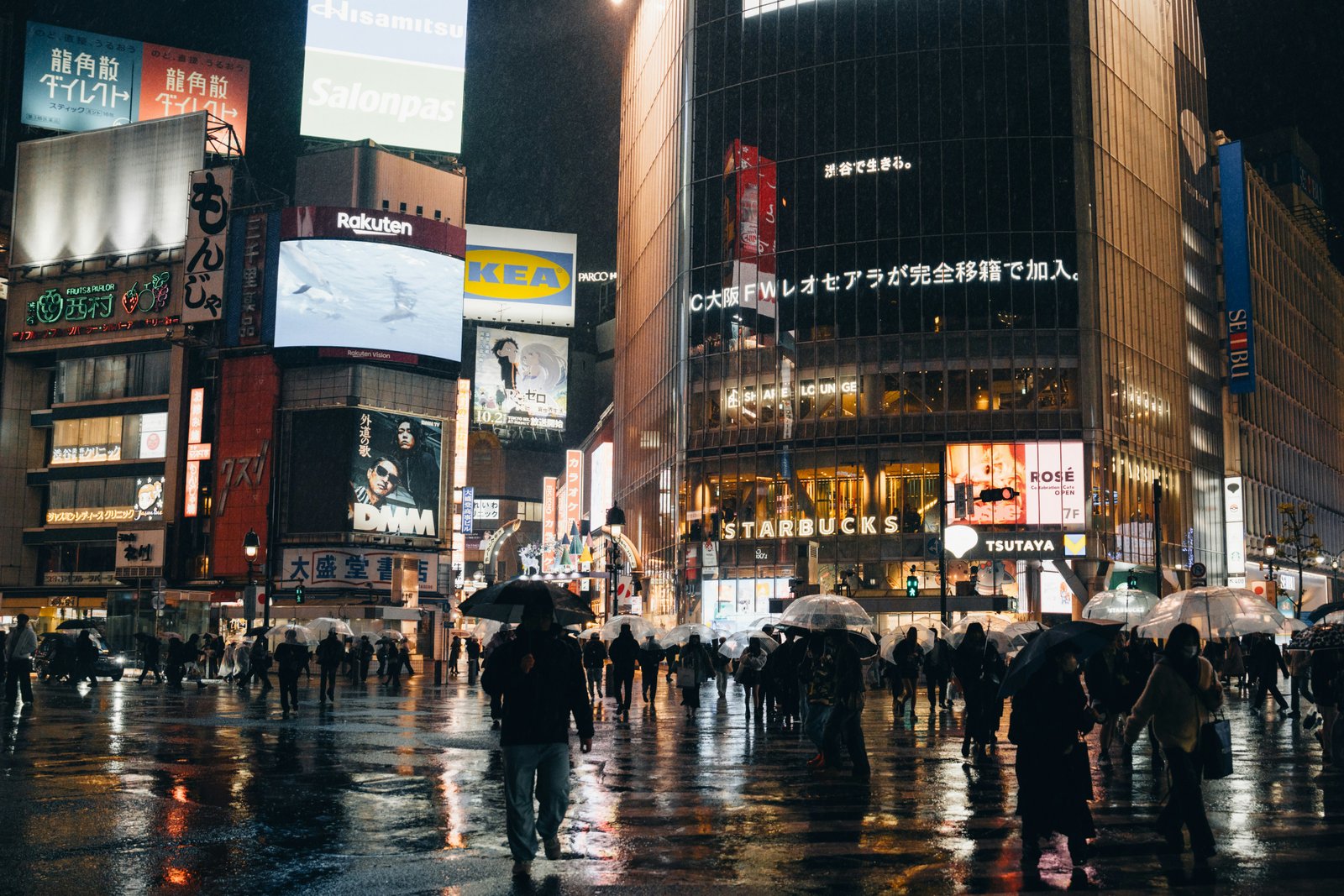 Sendai city centre at night with illuminated storefronts in the rain